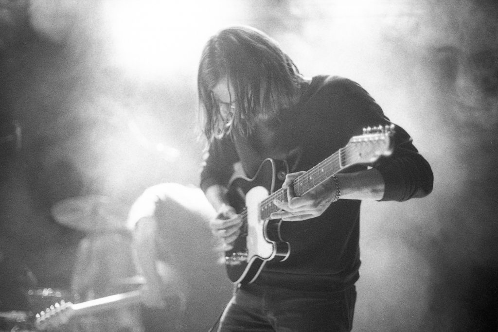 Black and white film photo of The Disappears in concert taken on HP5+