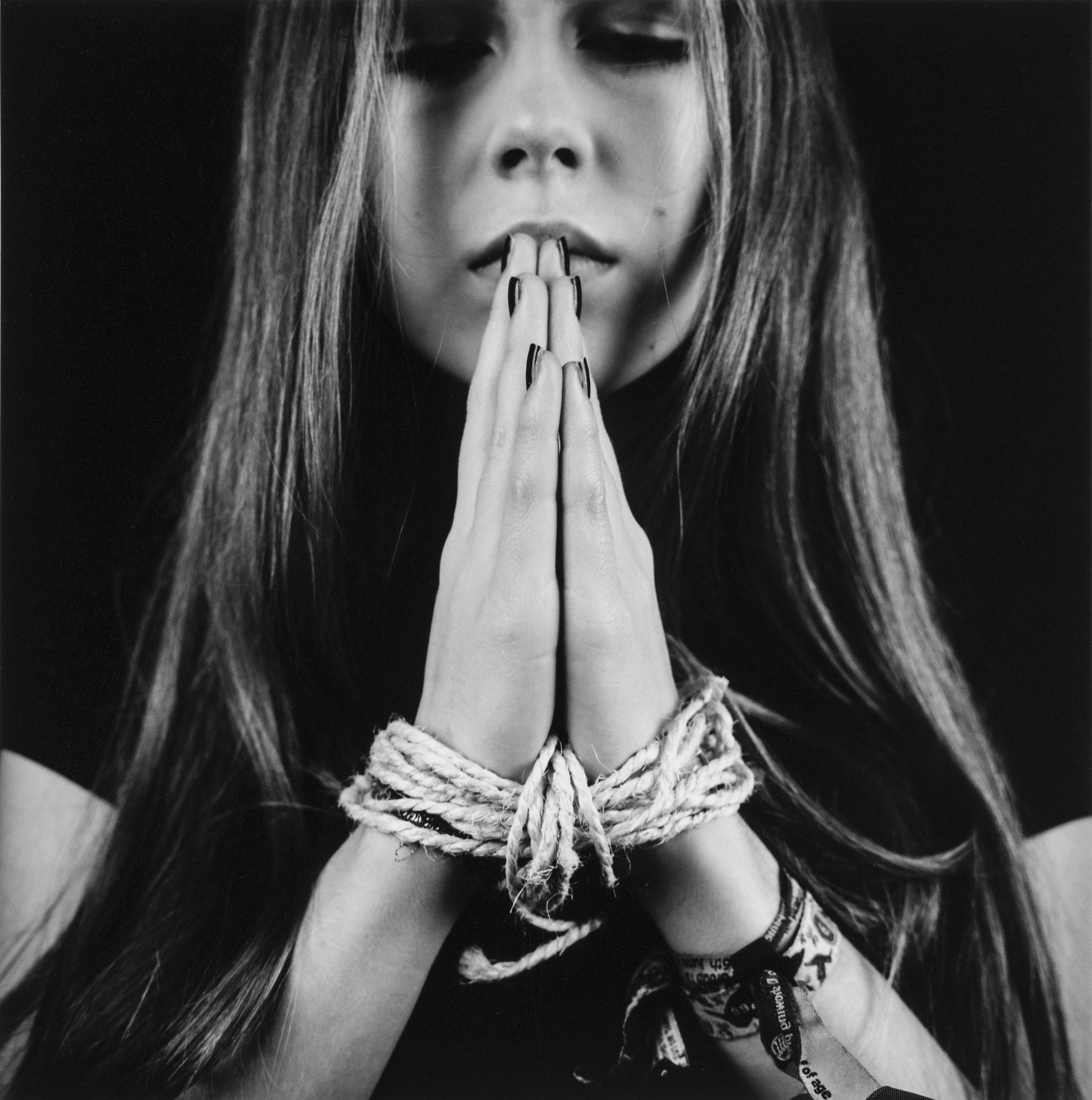 Black and white image of woman praying by Orla Simpson - ILFORD PHoto UK student photographer of the year