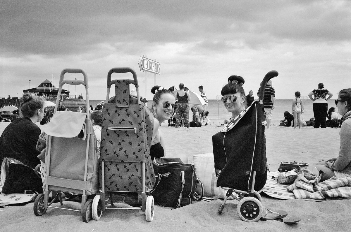 Black and white photo of Trolley girls #bythesea for #fridayfavourites. Shot by Monica Weller on Ilford XP2 film