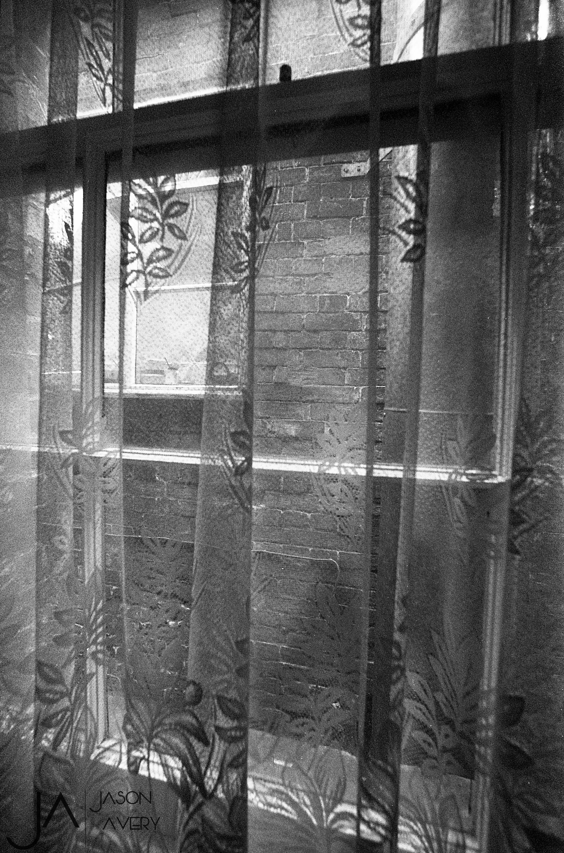 Black and white photo pof interior of old building shot on expired HP5 black and white film by Jason Avery