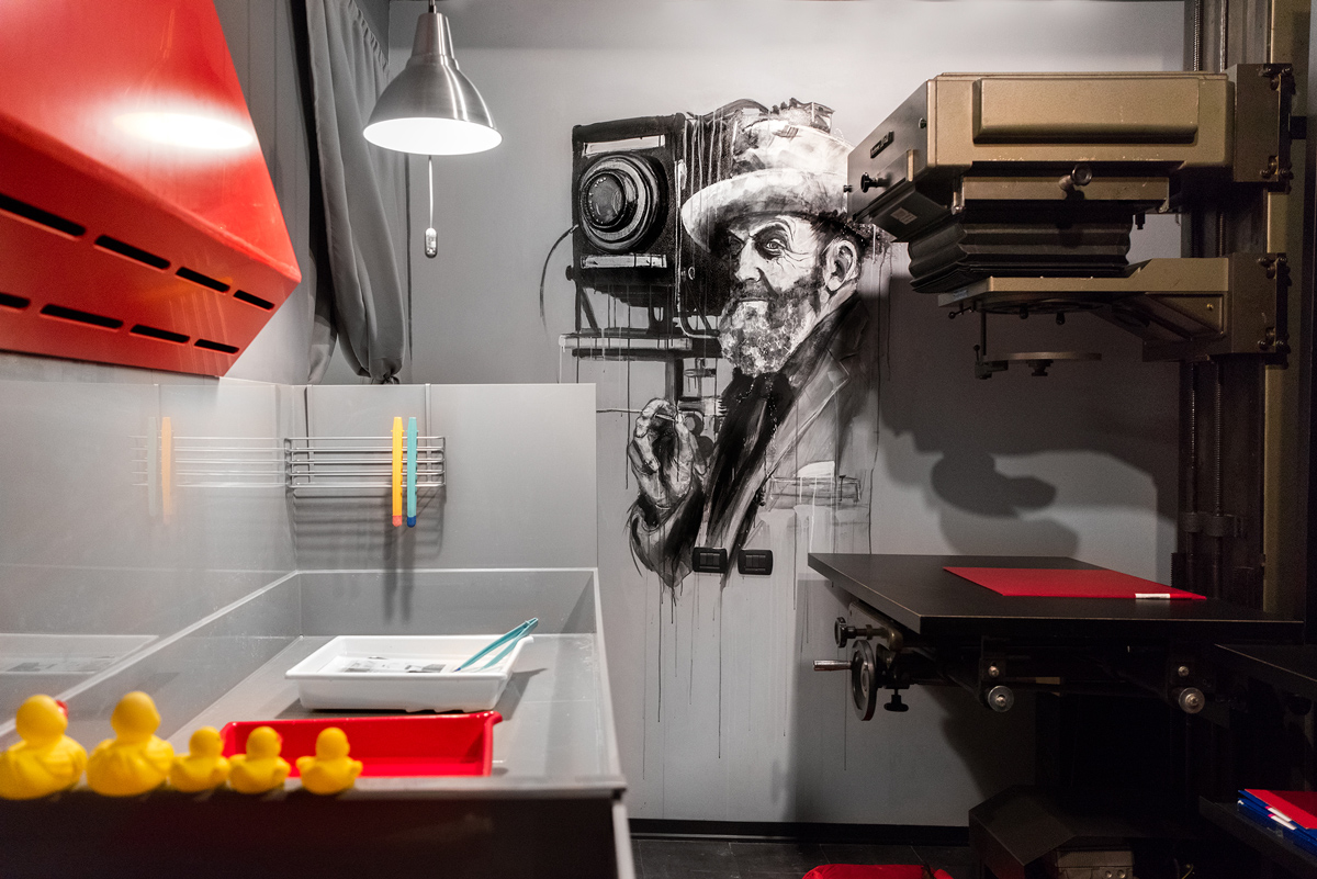 Lina Bessonova's darkroom with painting of Ansel Adams on the wall