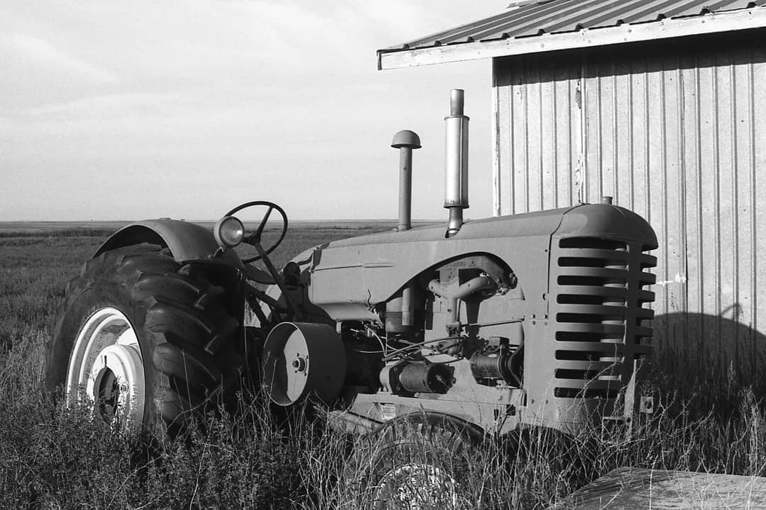  analogue_reverend Even old junk has a story. How many fields did this old tractor plow? Whose livelihood did it support? What did that farmer daydream about while he was driving it? . Shot on film: Canon AE-1; Ilford FP4 . #filmphotography #filmisnotdead #canonae1 #ilfordphoto #ilfordfp4 #rural #tractor #overlooked #analoguevibes #fridayfavourites