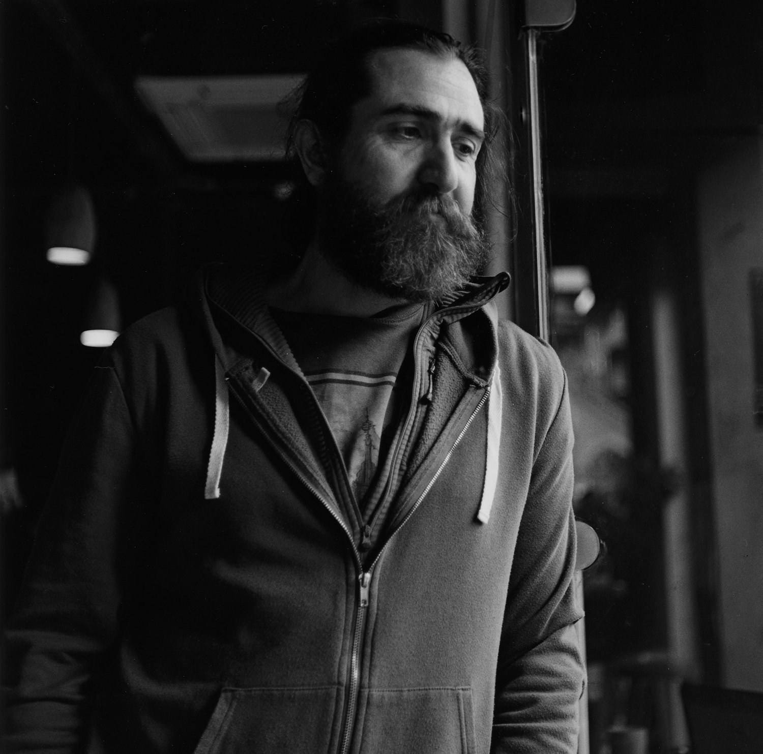 Portrait of a man in a cafe shot on ILFORD black and white film by Keith Moss