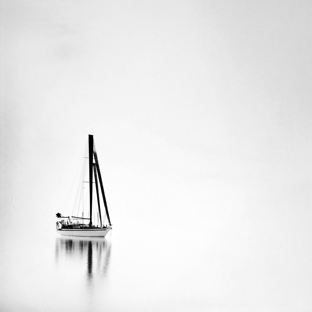 a boat surrounded by white like milk, water. Although in fact it was taken at night. I decided I would leave it as a negative as soon as I saw the film after development. I think this is the rare case when a photograph looks better as a negative. It was taken with Ilford film and to print this as a negative I use Ilford direct positive paper. 