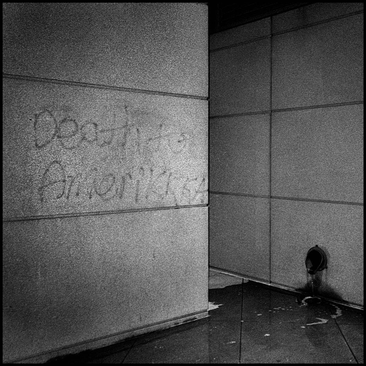 The words, “Death to Amerikkka” power washed from a building near the Colorado state capitol. Dencer, CO. Ilford Delta 400.