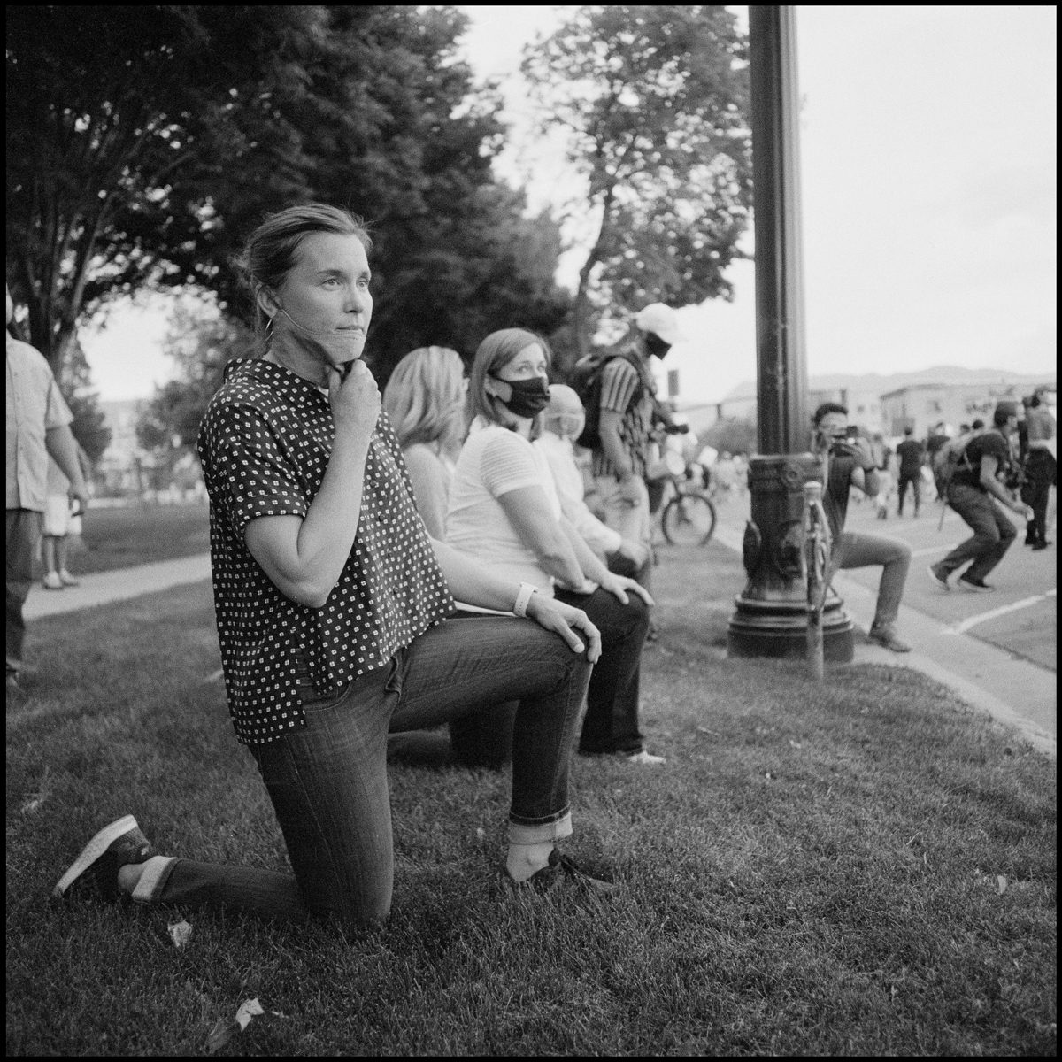 Salt Lake City Mayor, Erin Mendenhall, kneels as protestors march past the county building. Salt Lake City, UT. Ilford Delta 400.