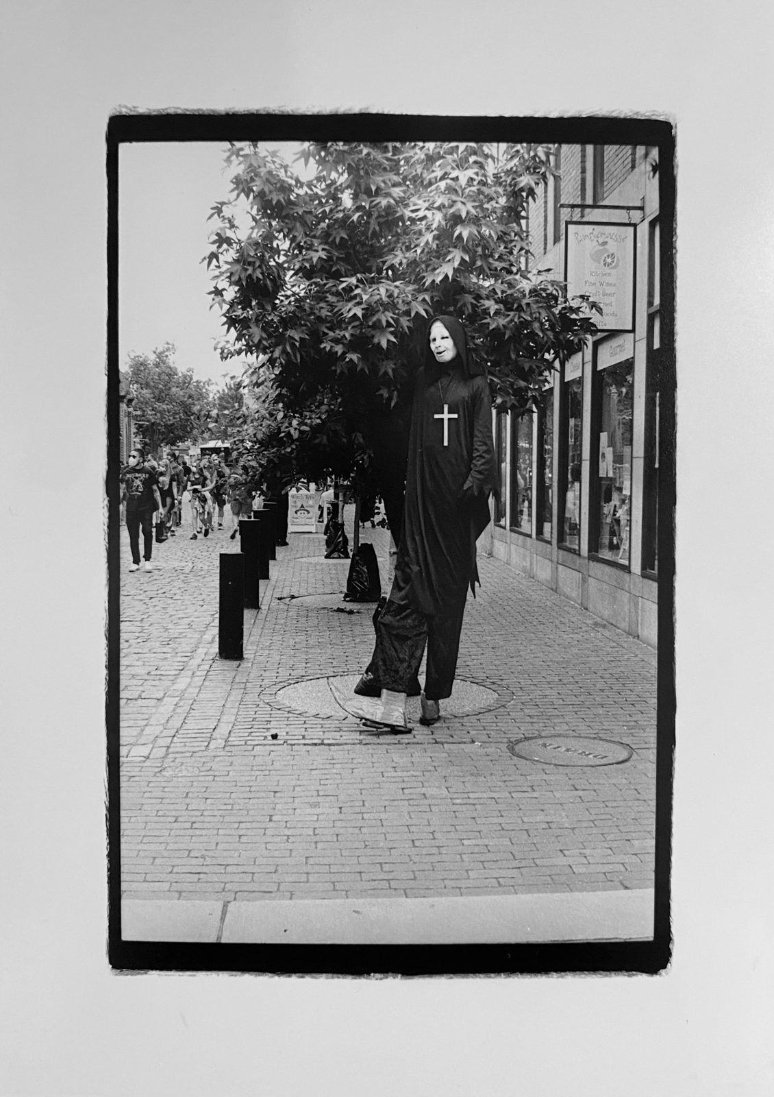 “stilts-with-cross”-local-character shot on ILFORD HP5 plus film by Jessica Martinea