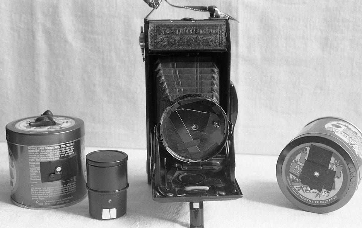 Pinhole Cameras, l to r: Lozenge tin, film cannister, converted 6x9 Voigtländer, lozenge tin © M C Fitzgerald