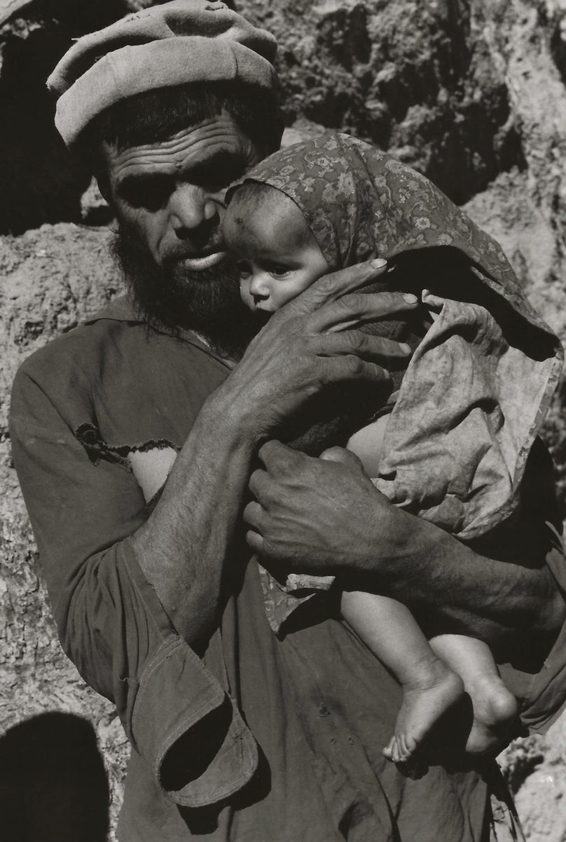 Black and white photograph of a father holding his baby daughter closedaughter