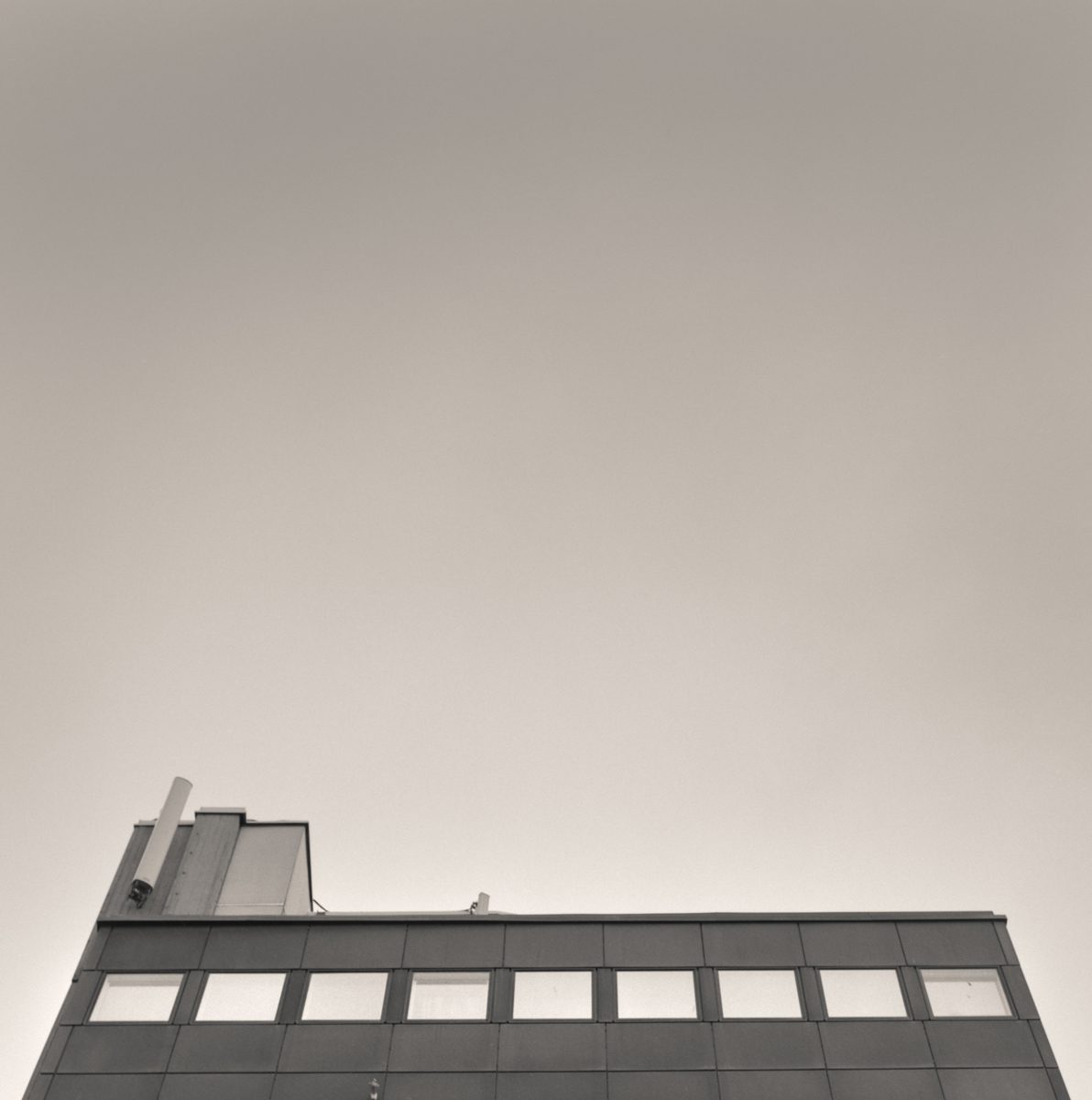 Black and white photograph of buildings looking up from below