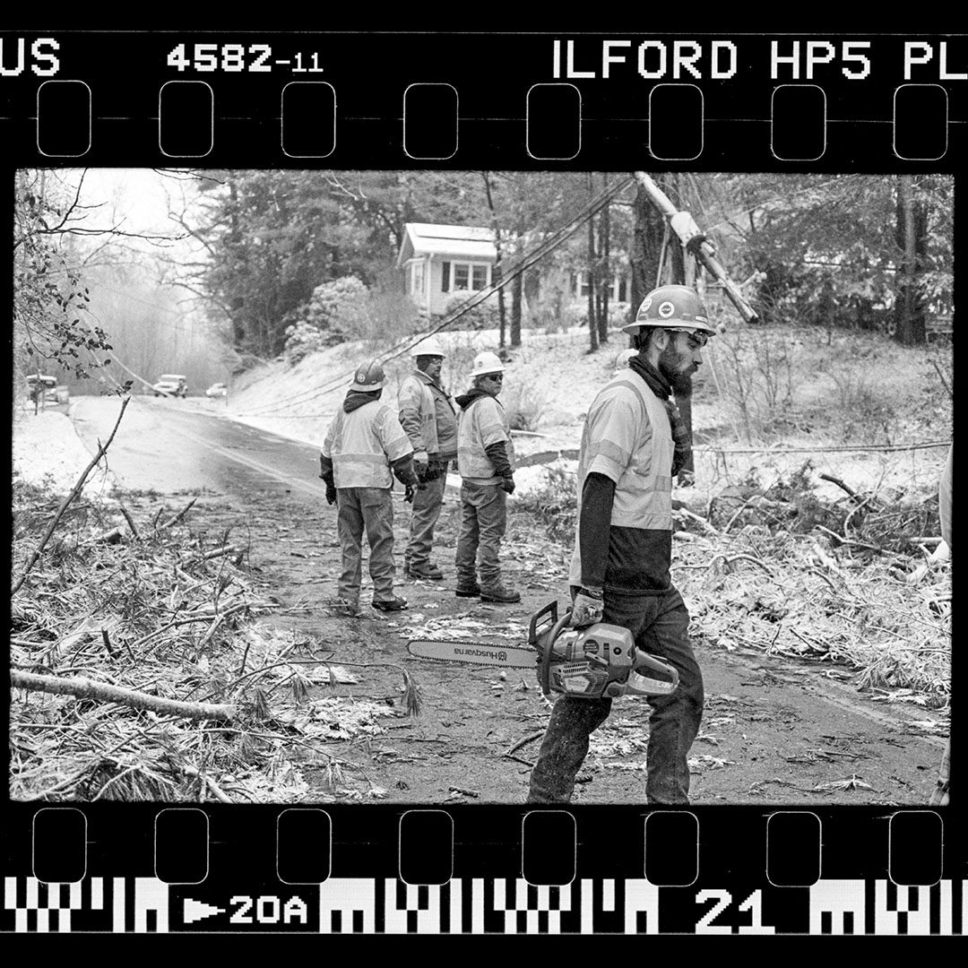 Black and white image of men working in the snow