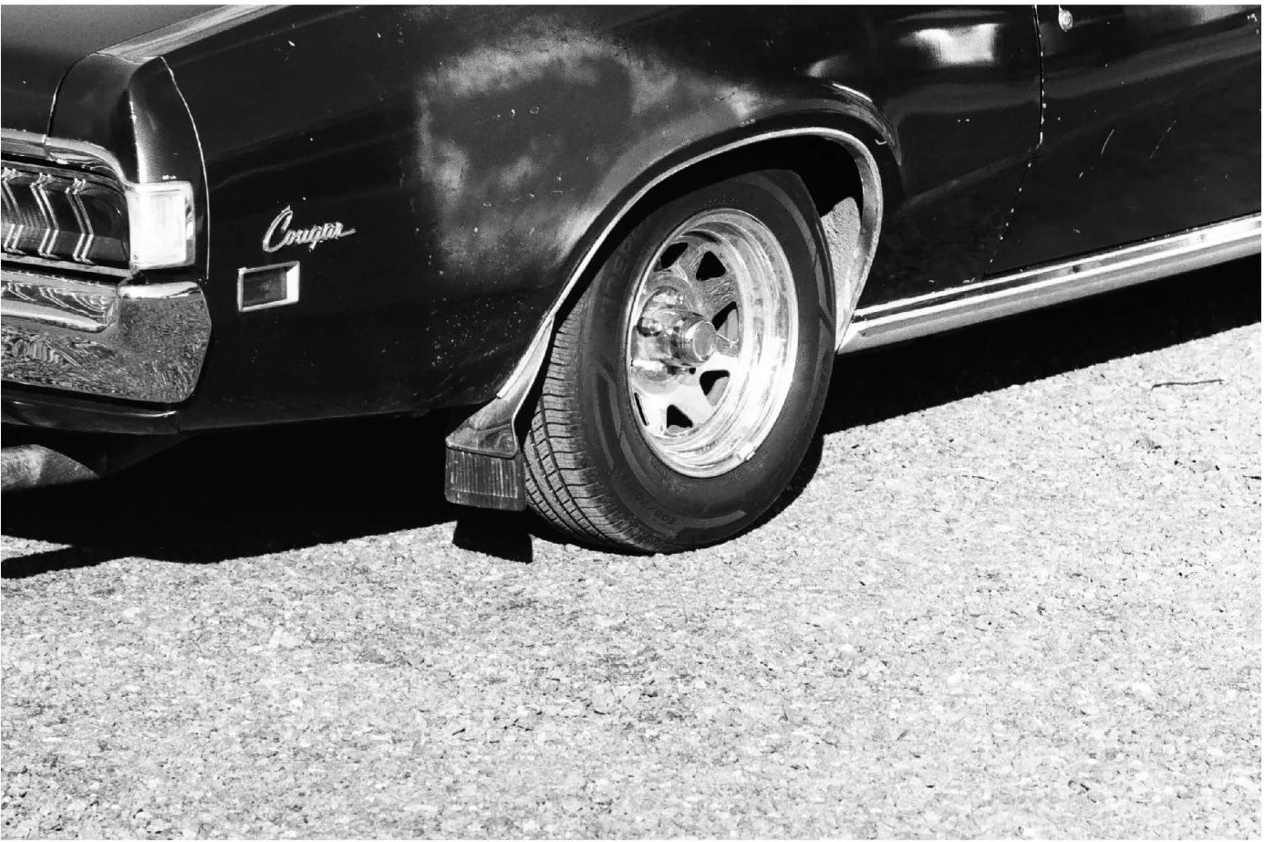 Black and white analogue photograph of a car