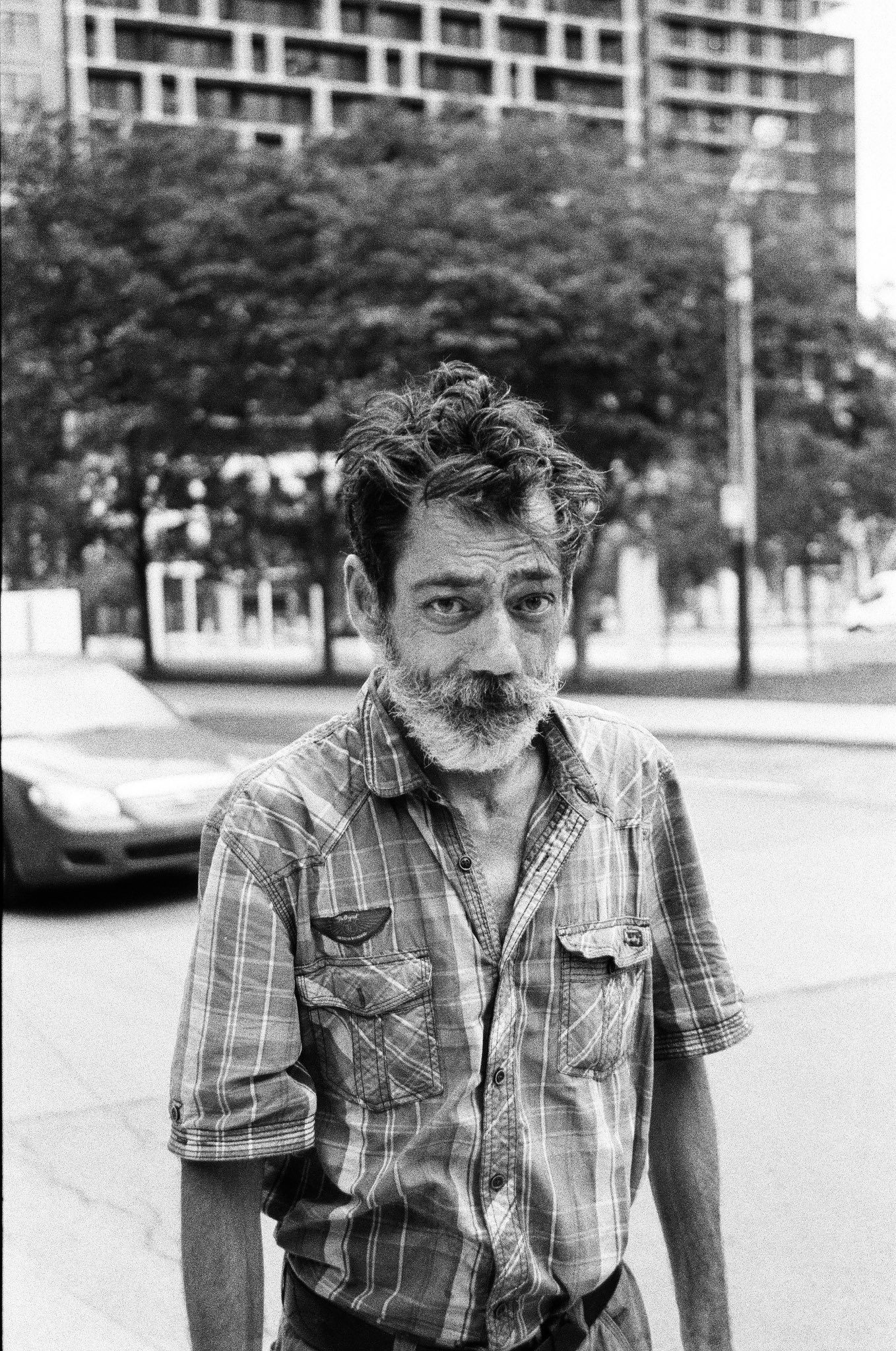 Black and white portrait of a man in the street