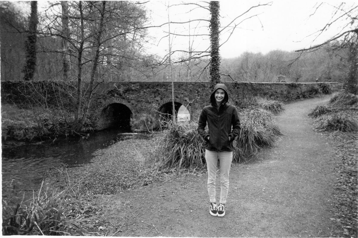 Black and white girl stood in the countryside with her hands in her pocket