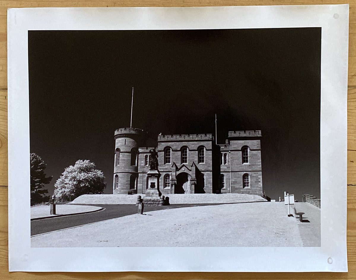 Black and white darkroom print of a candle on a sunny day 