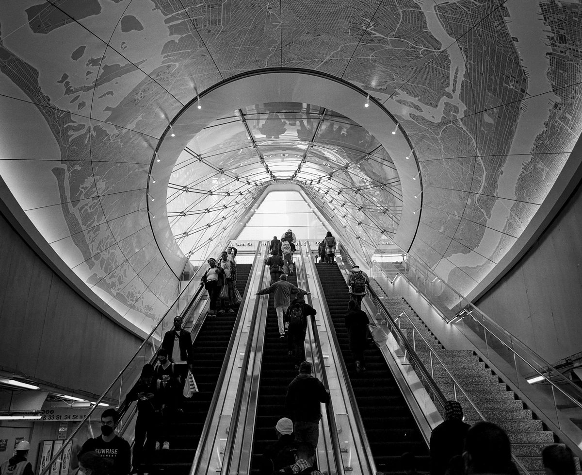 Black and white photo of escalators going up