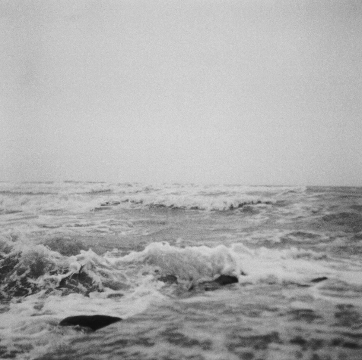 Black and white image of an angry sea with powerful waves