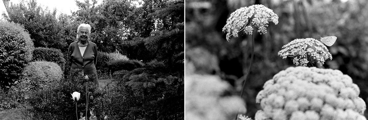 Black and white photo of a flower and an elderly woman