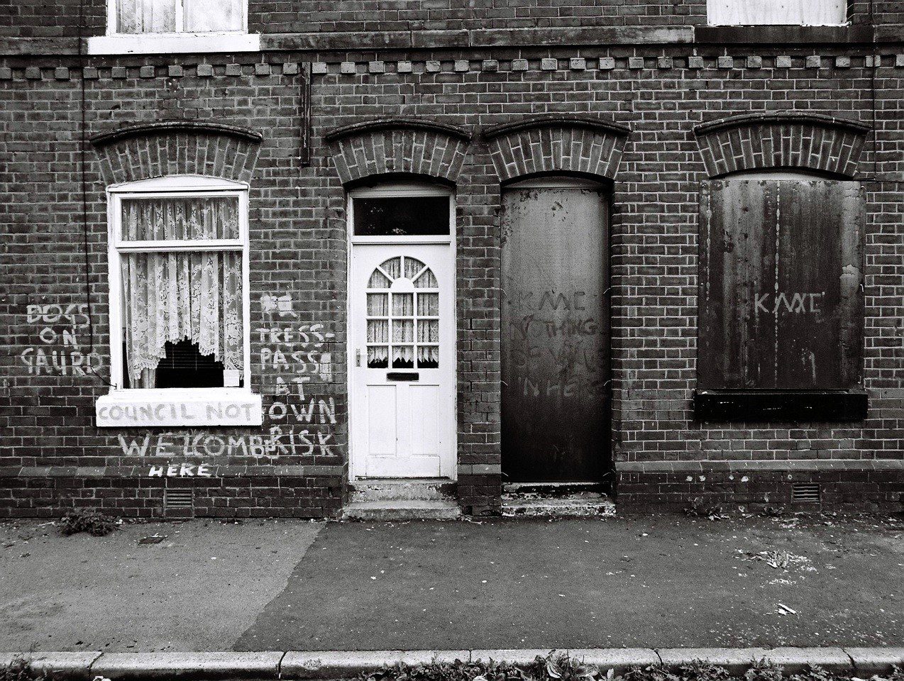 Black and white photo of street with houses