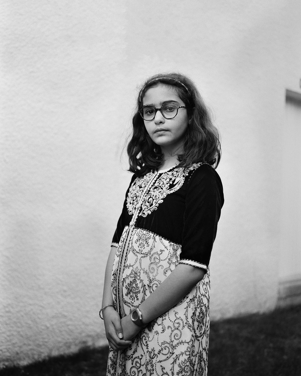 Black and white portrait of a girl stood up
