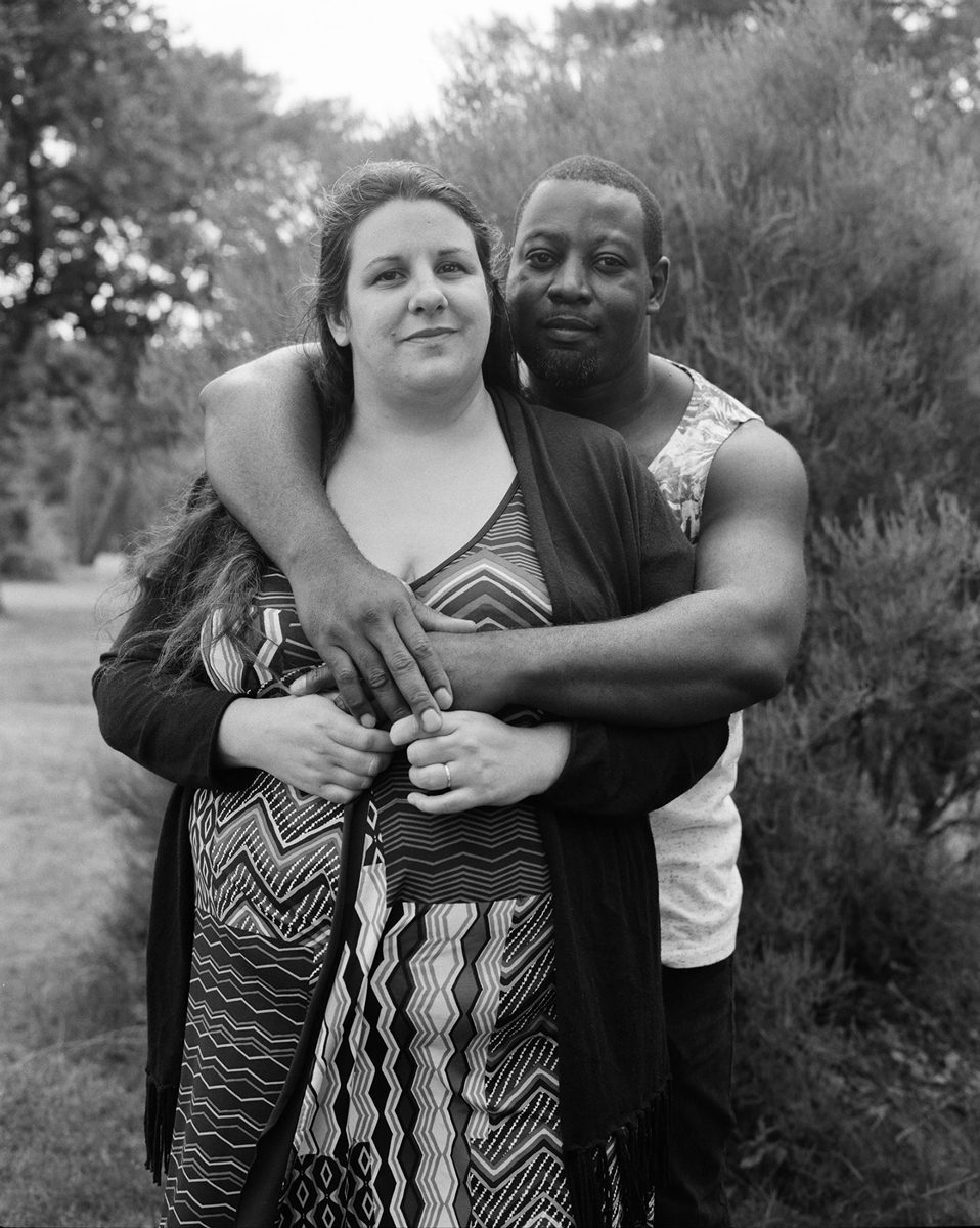 Black and white portrait of two people hugging