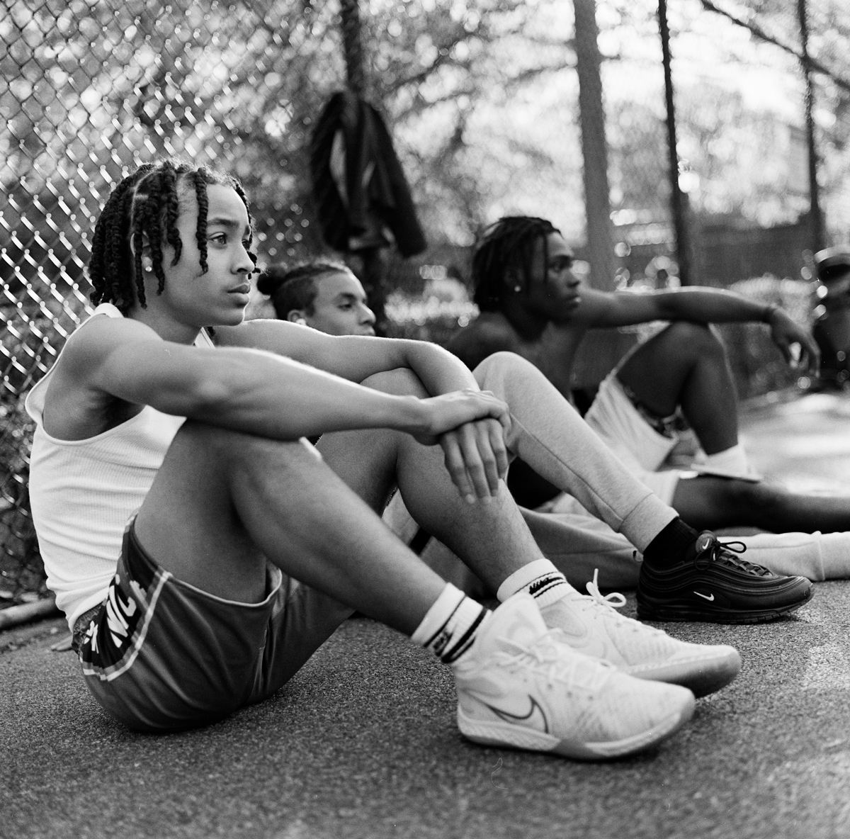 Men sat down on the basketball court