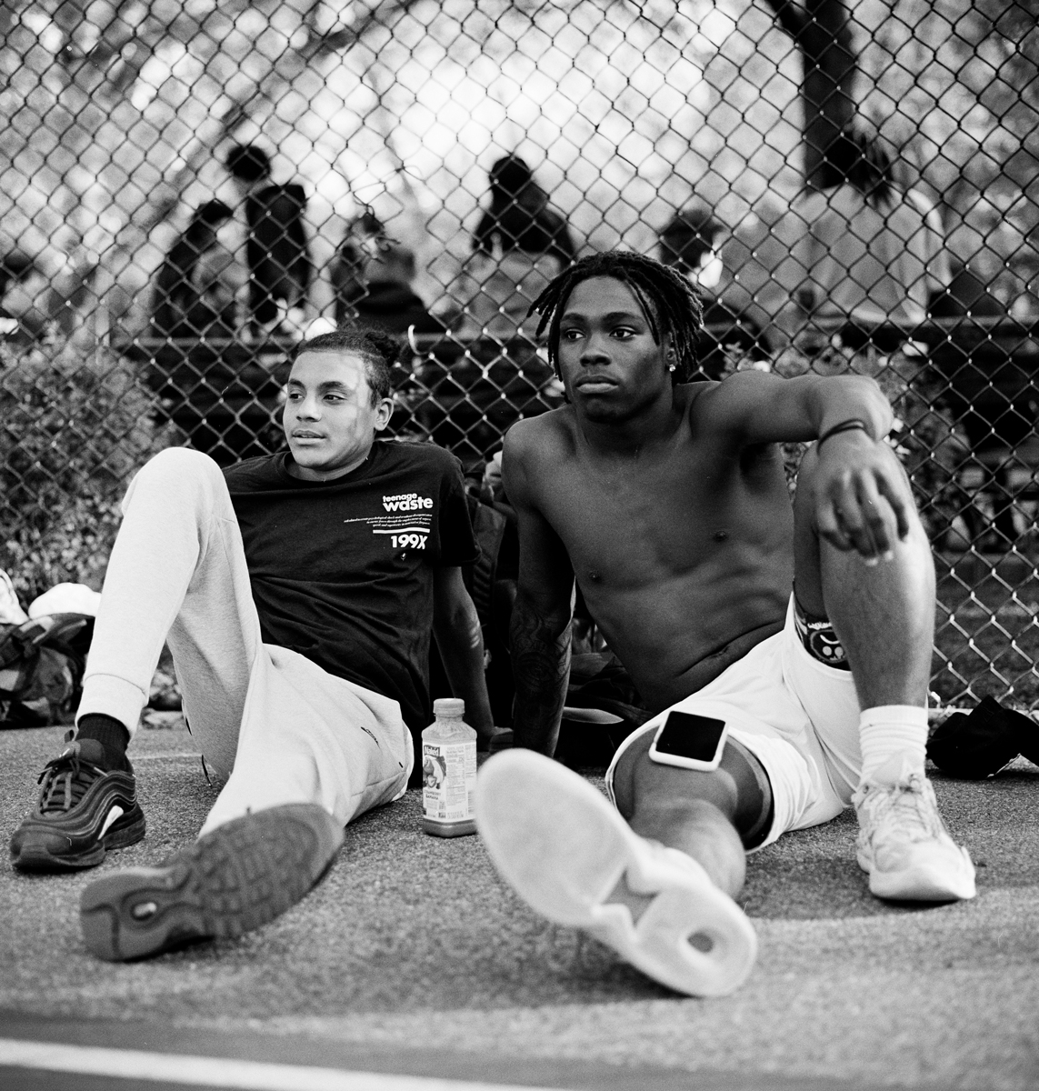 Two men sat down on a basketball court