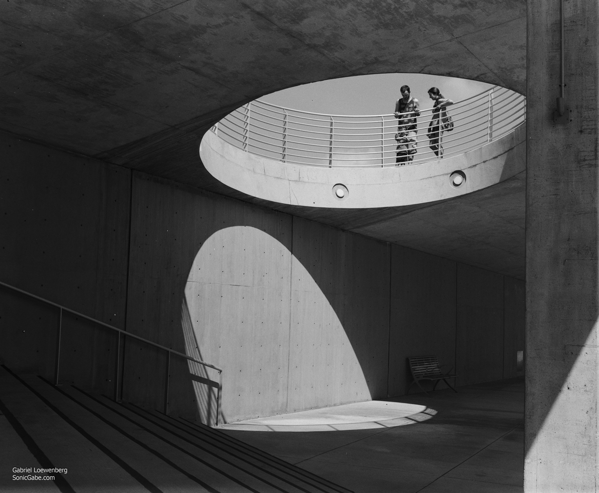 Inside a building with two people looking down