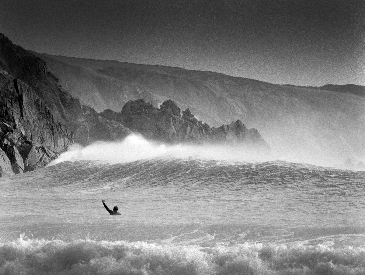 Man in the ocean waving 