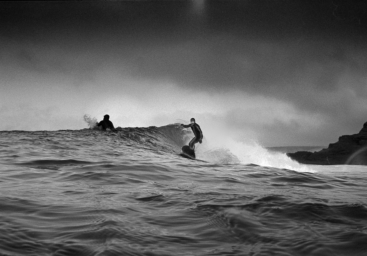 Two people surfing on the ocean