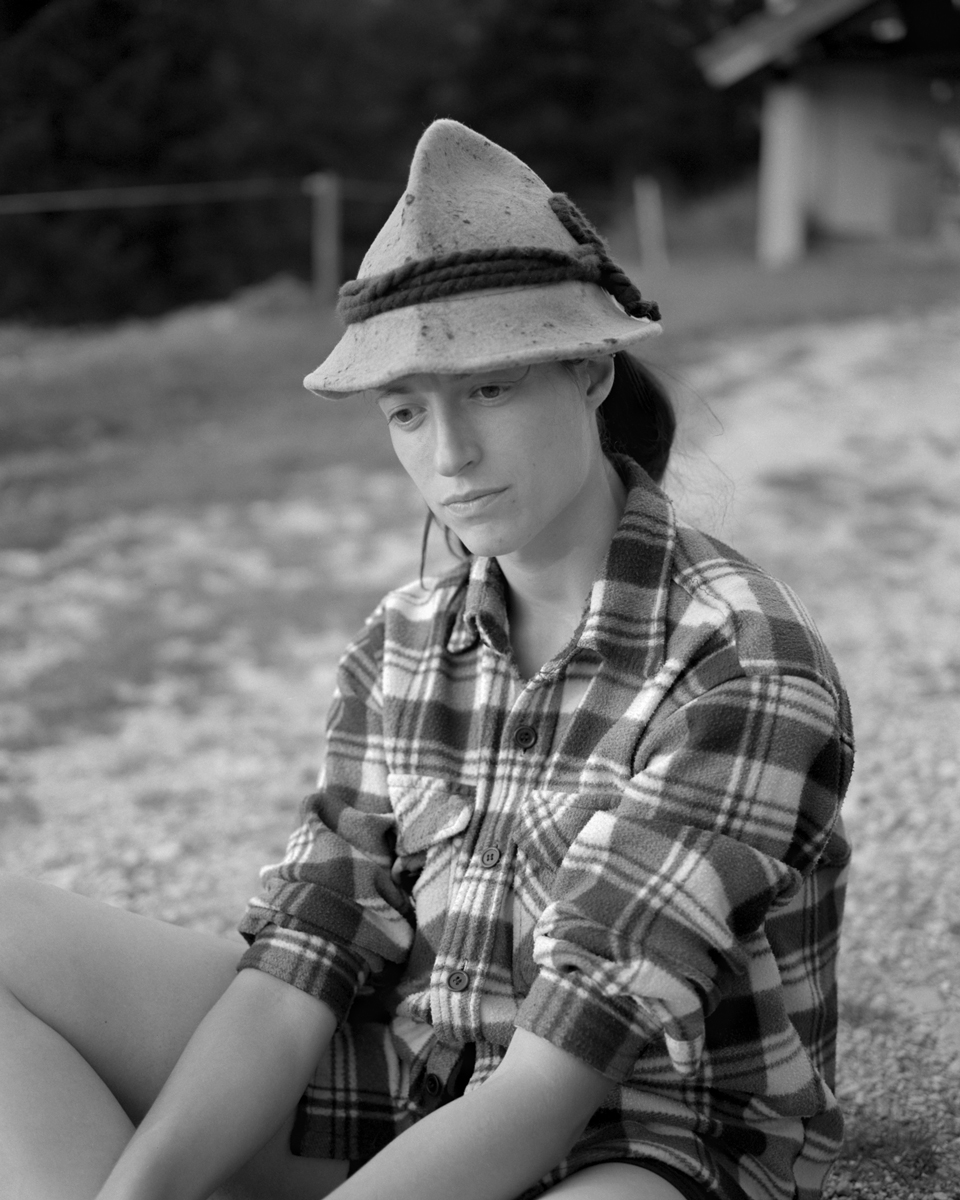 Female sat on the grass on a farm