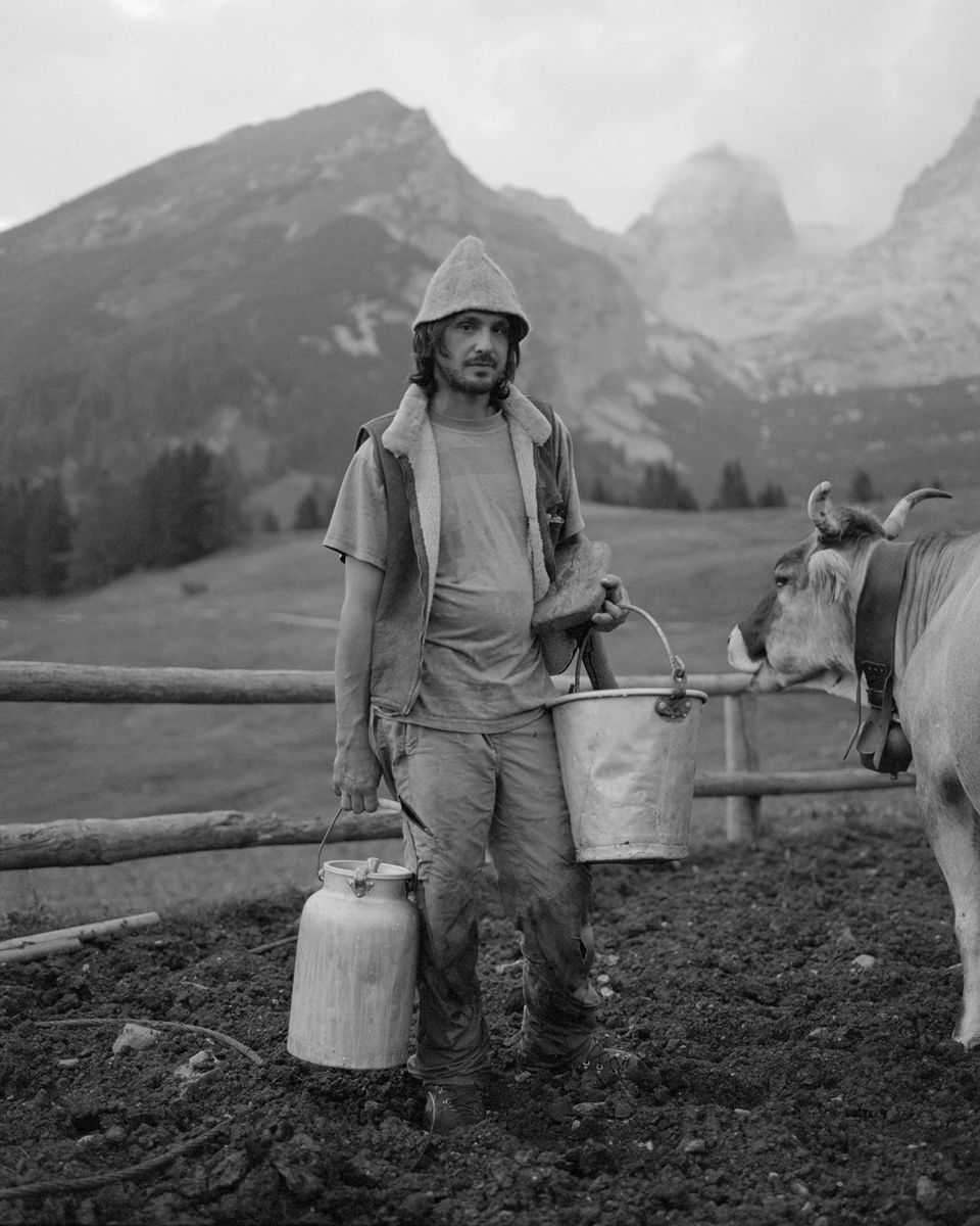 Man in the mountain holding a bucket