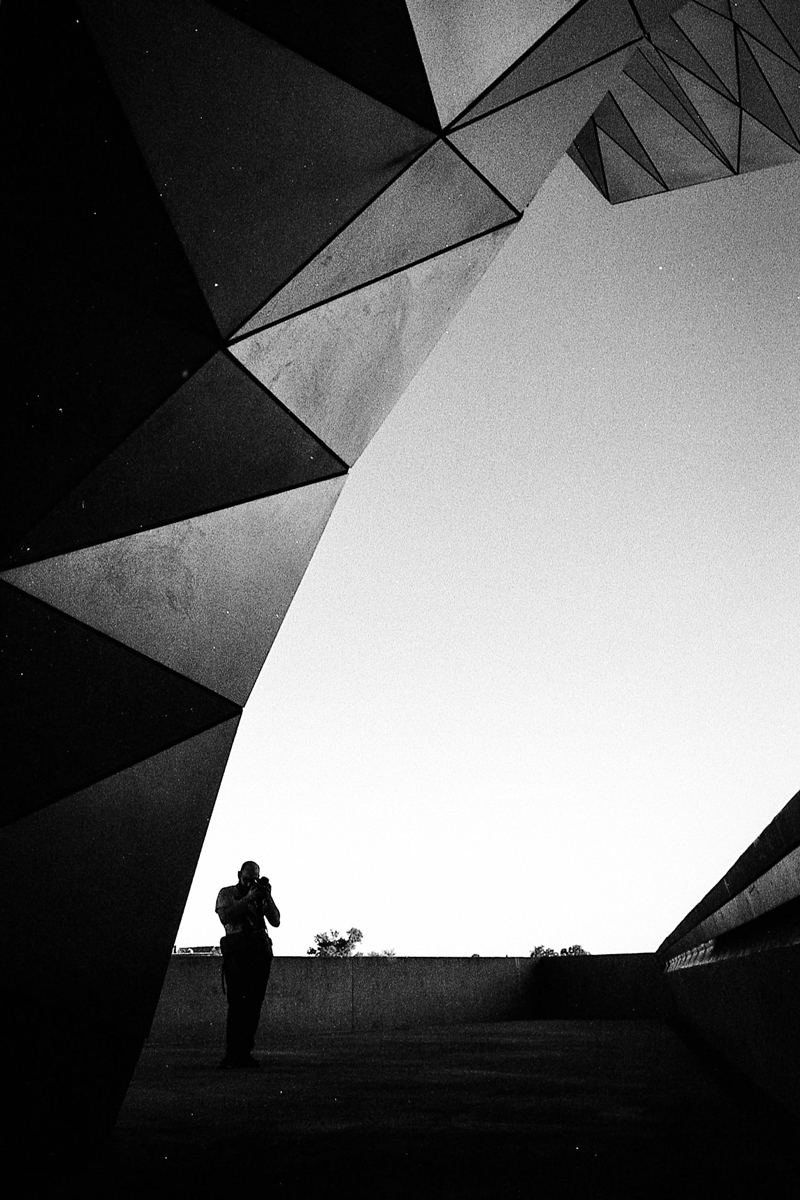 Black and white high contrast looking through a arch of a building