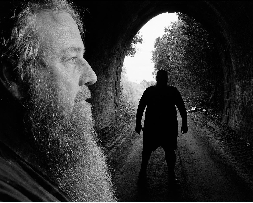 Black and white double exposure of a man with a long beard