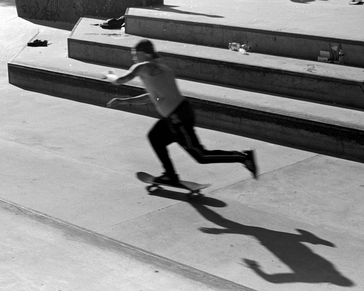 Blurred black and white phoito of a man skateboarding