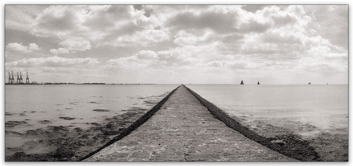 Sepia photograph of the sea with a path leading into the ocean #leadinglines