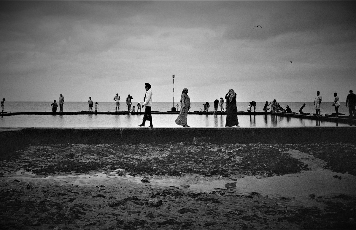 Black and white photo of people on the beach