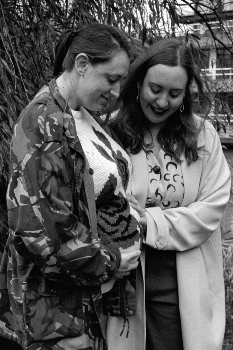 Black and white portrait of a ouple of woman who are pregnant