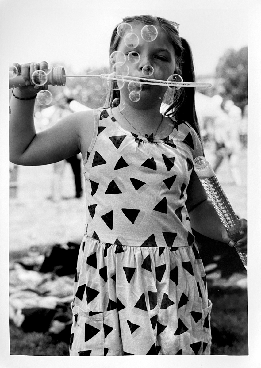 Young girl blowing bubbles 