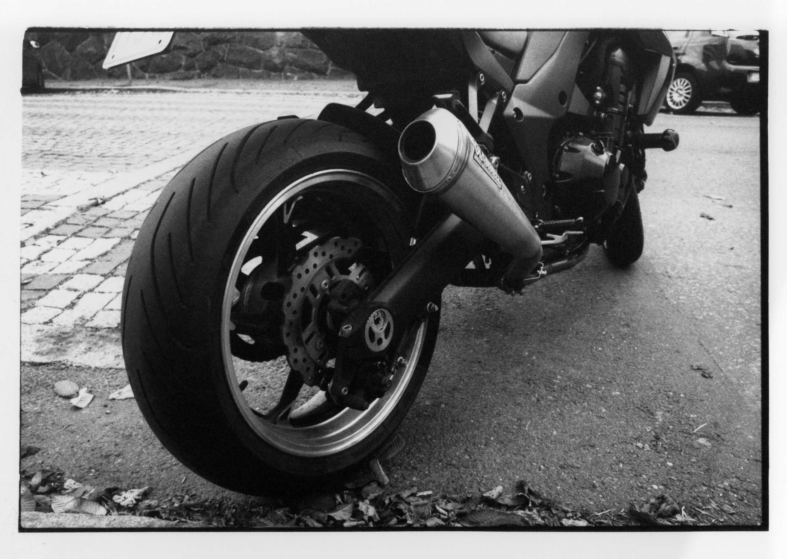 lack and white photo of the back tyre on a motorbike