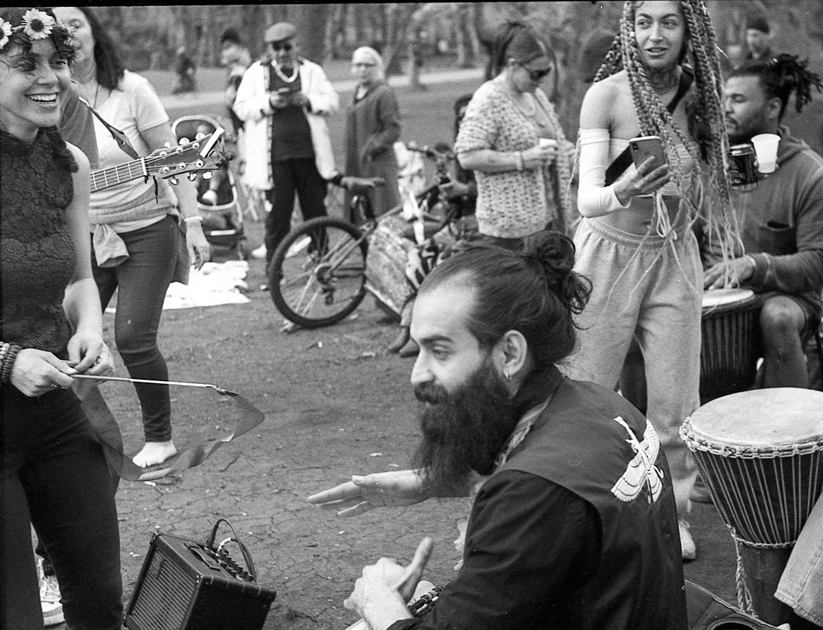 Group of people sat with instruments, drinks laughing