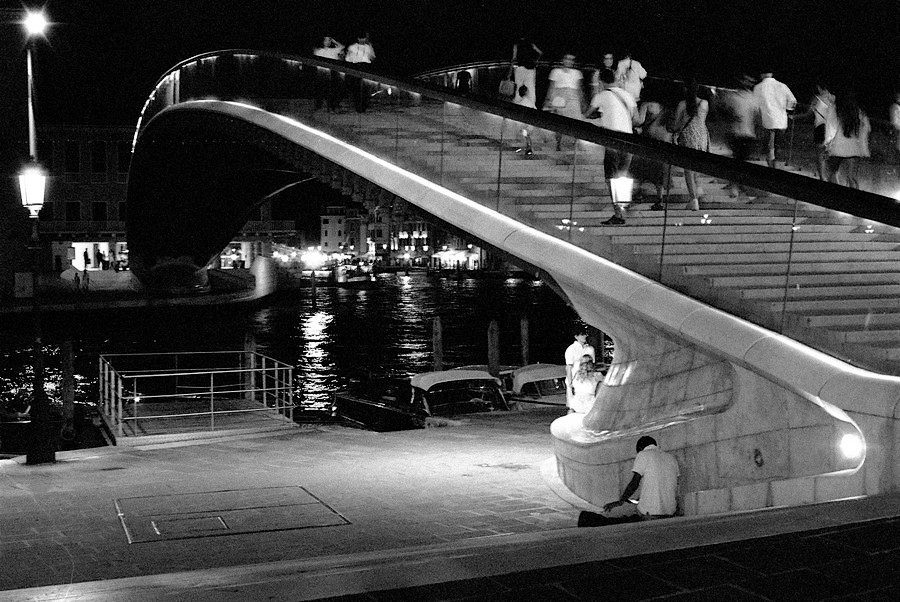 Julian Tanase. Black and white shot of a bridge in Venice at night.