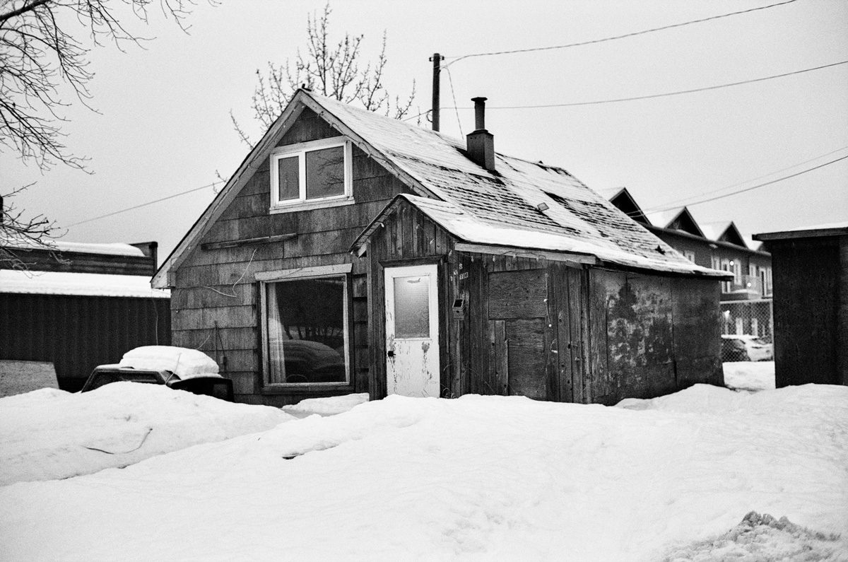 Black and white cabin in snow