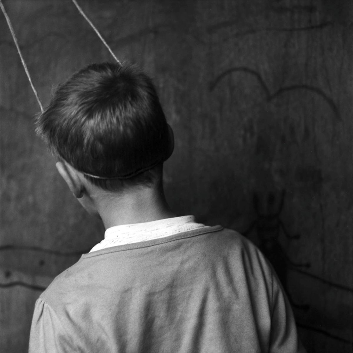 Black and white image of the back of a boys head