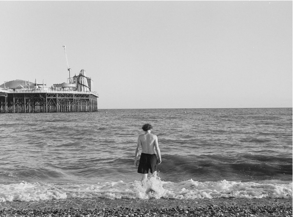 Black and white shot of a man in the sea