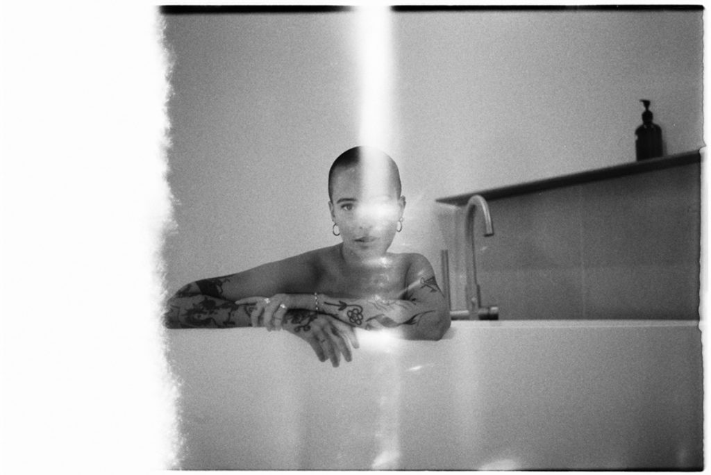 Black and white portrait of a woman in the bath tub