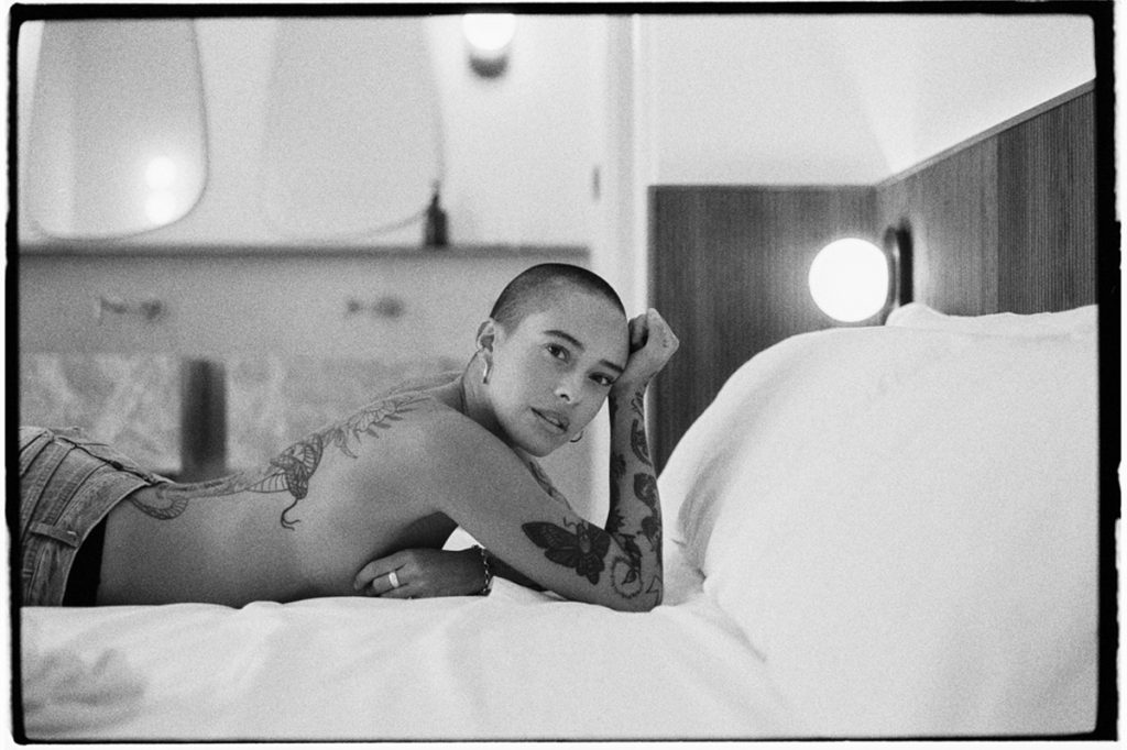 Black and white portrait of a woman on a bed
