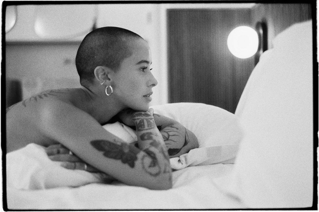 Black and white portrait of a woman on a bed
