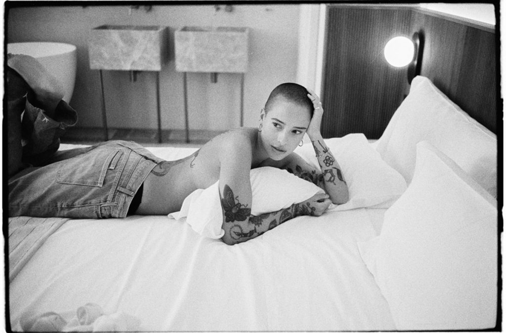 Black and white portrait of a woman on a bed