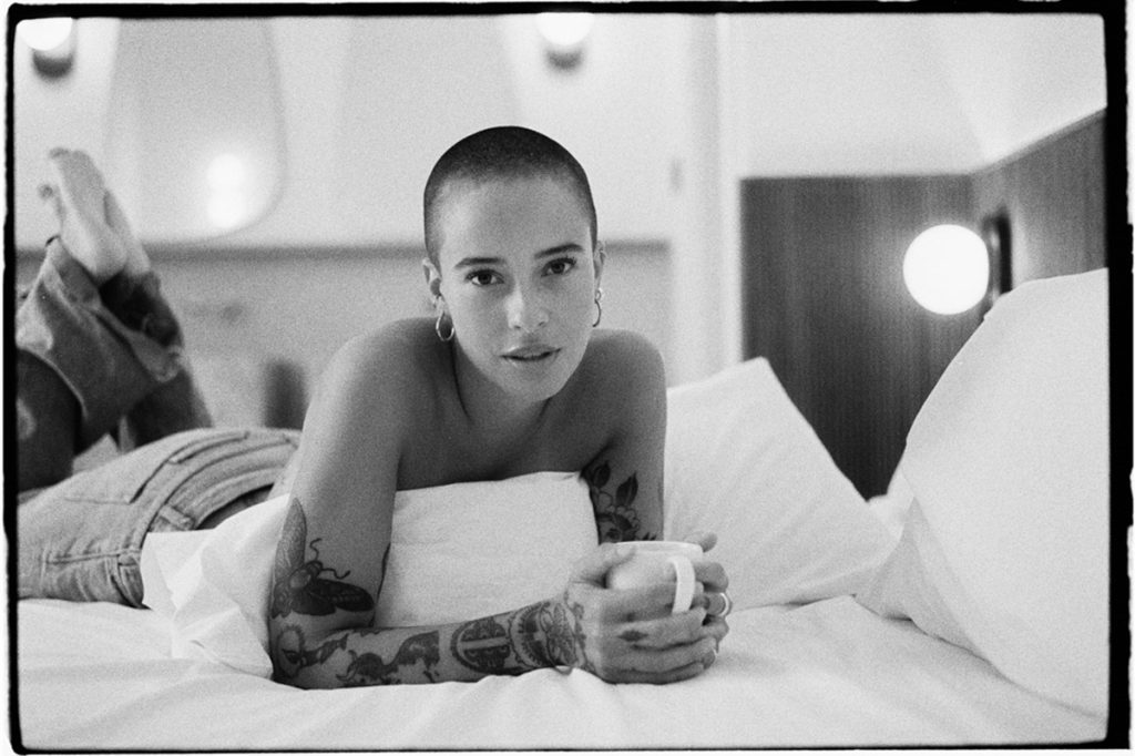 Black and white portrait of a woman on a bed